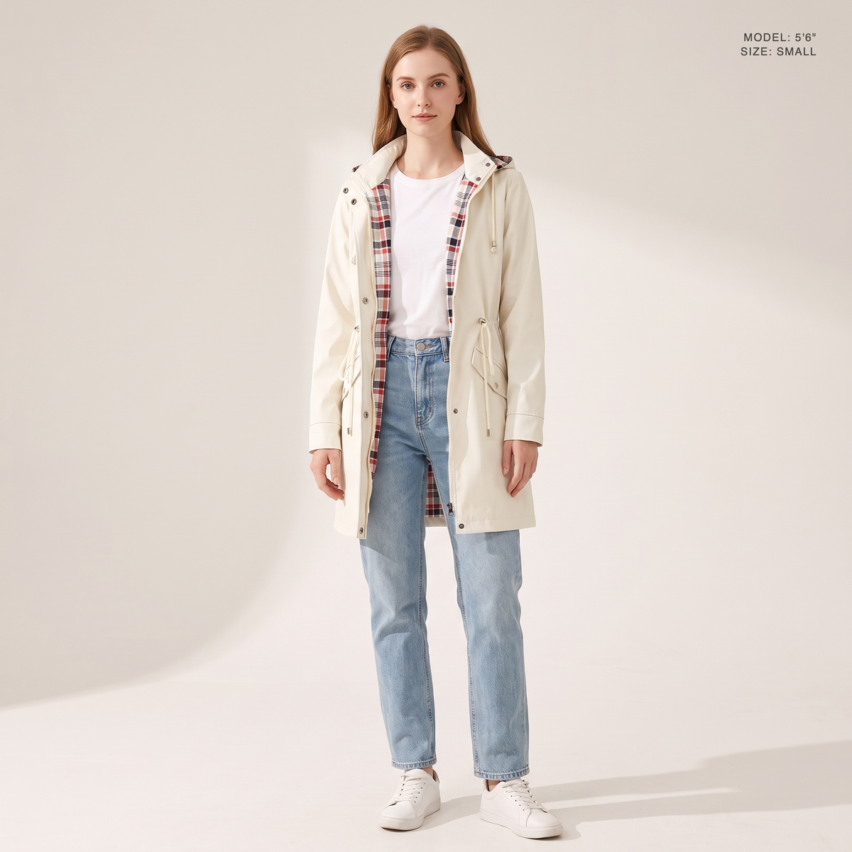 The Ashby Hooded Rain Trench in Ivory White, worn open to show the plaid flannel lining, model 5 foot 6 wearing size Small