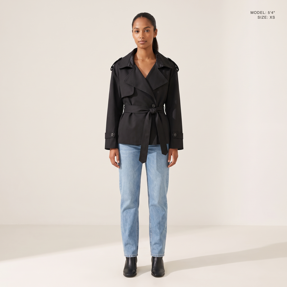 The Bexley Lapel Trench in Black, front view, model 5 foot 4 wearing size XS