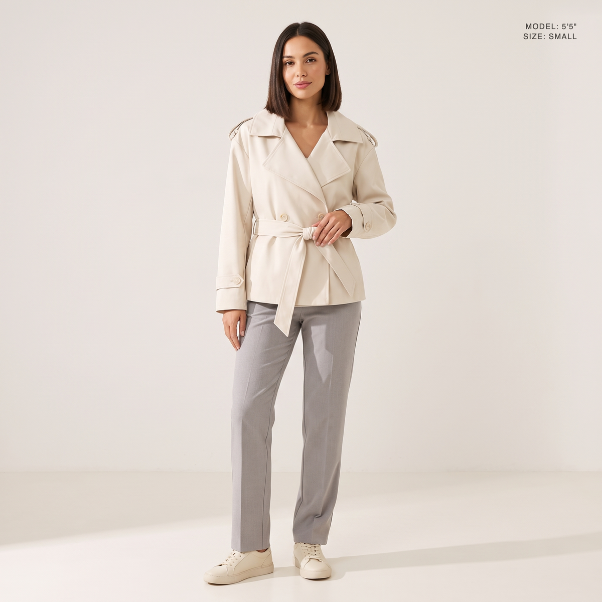 The Bexley Lapel Trench in Milky White, front view, model 5 foot 5 wearing size Small