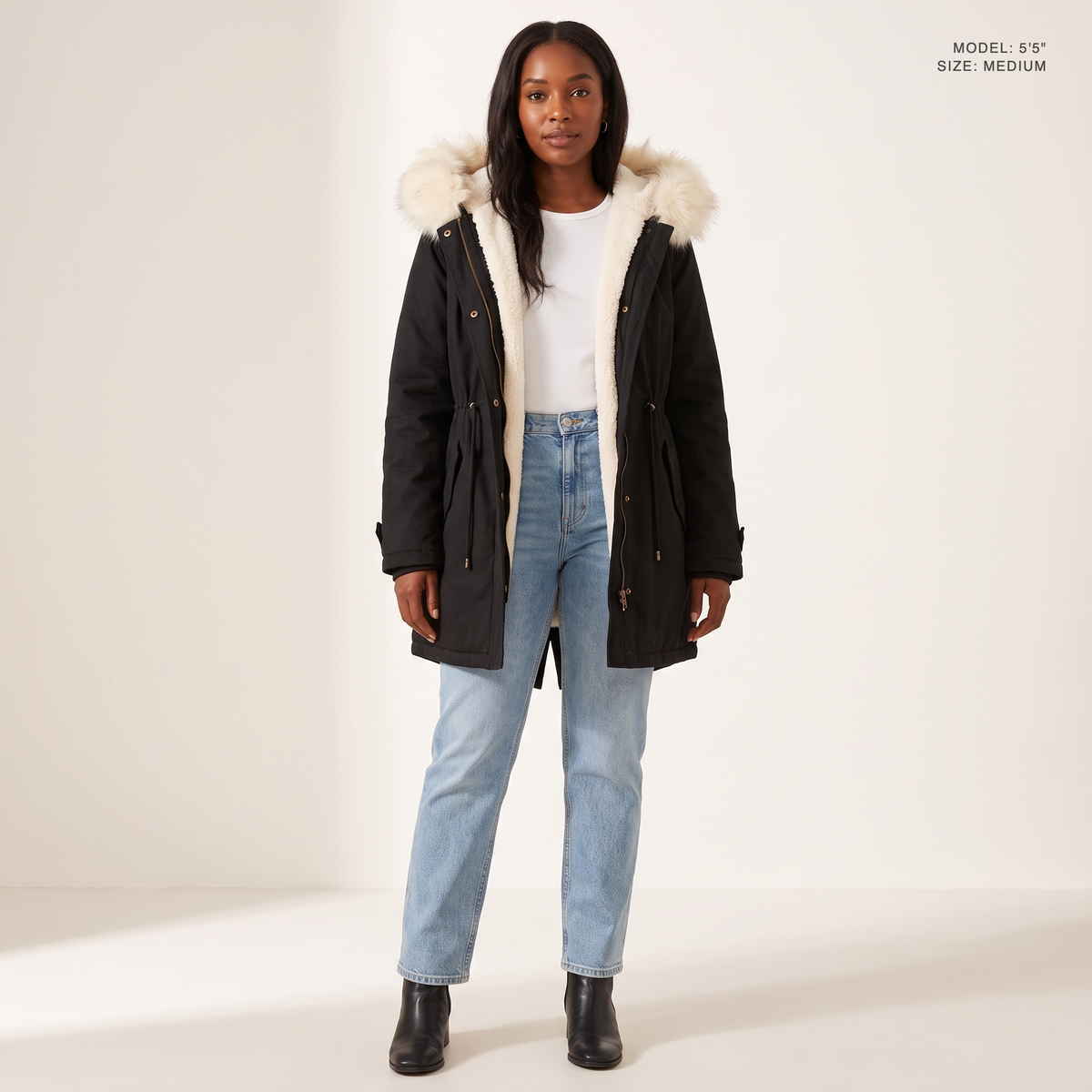 The Camden Sherpa Parka in Black, worn open to show the sherpa fleece lining, model 5 foot 5 wearing size Medium