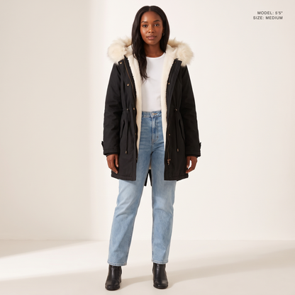 The Camden Sherpa Parka in Black, worn open to show the sherpa fleece lining, model 5 foot 5 wearing size Medium