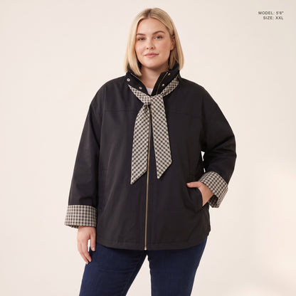 The Hartley Hooded Windbreaker in Black with the plaid scarf knotted at the collar, model 5 foot 6 wearing size XXL