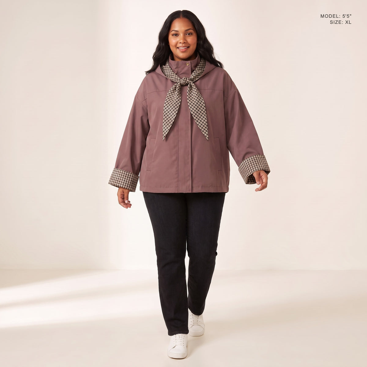 The Hartley Hooded Windbreaker in Plum with the plaid scarf knotted at the collar, model 5 foot 5 wearing size XL