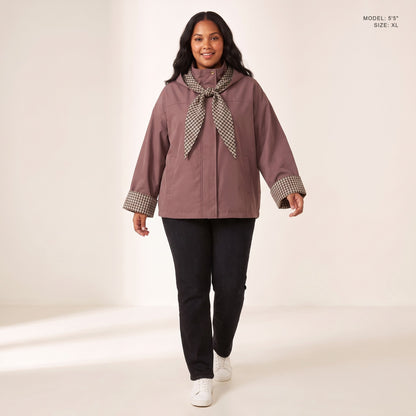 The Hartley Hooded Windbreaker in Plum with the plaid scarf knotted at the collar, model 5 foot 5 wearing size XL