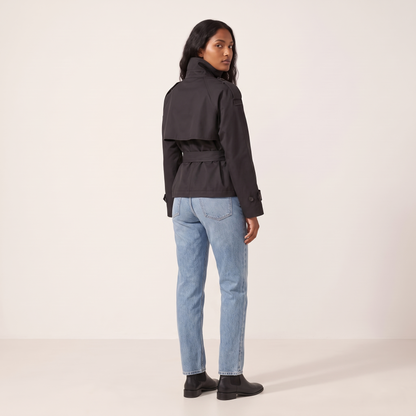 The Halston Cropped Trench in Black, back view showing the cape storm flap and belted waist