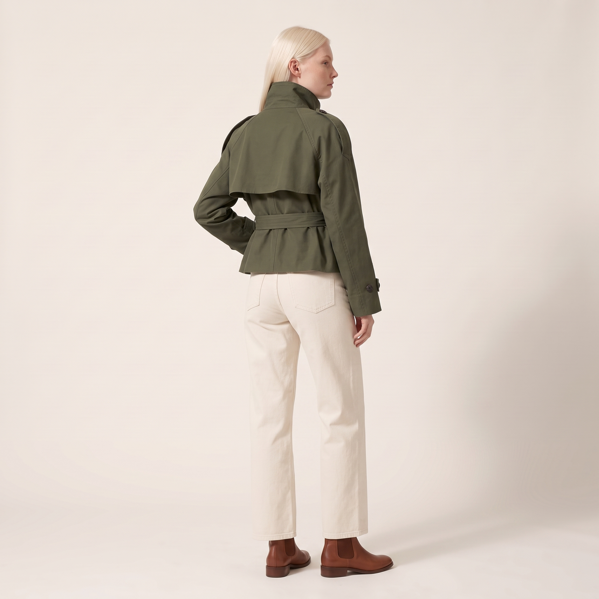 The Halston Cropped Trench in Army Green, back view showing the cape storm flap and belted waist