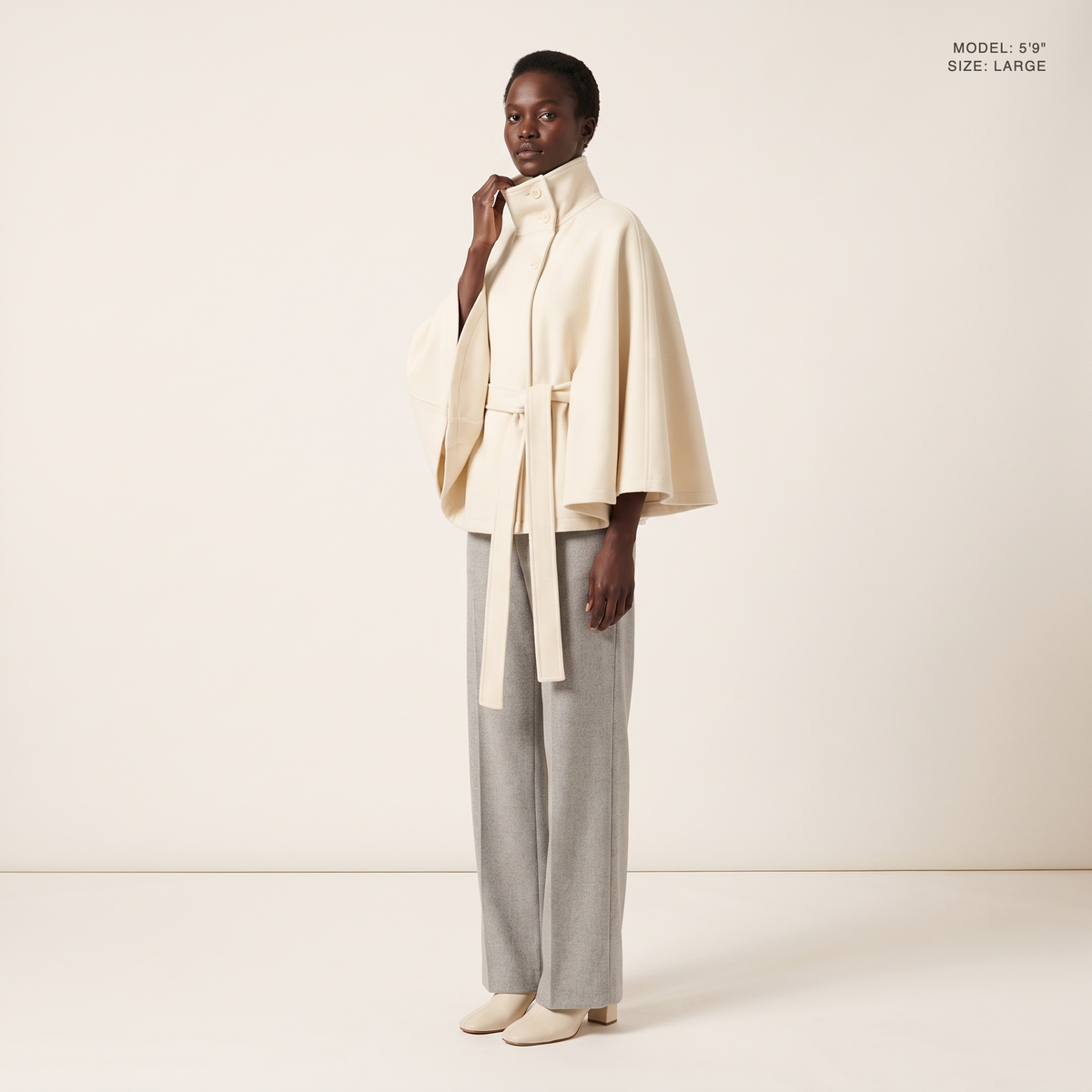 The Marlowe Cape Coat in White, front view, model 5 foot 9 wearing size Large